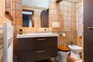 a bathroom with a sink and a toilet at Dal Cappellaio Matto in Taranto