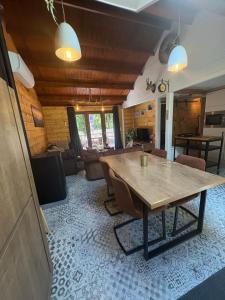 a living room with a wooden table and a couch at Chalet 9 La Boverie in Rendeux