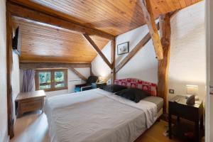 a bedroom with a bed and a wooden ceiling at Chalet La Grange Courchevel in Courchevel