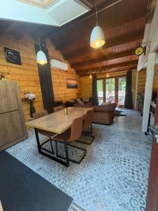 a living room with a wooden table and a couch at Chalet 9 La Boverie in Rendeux