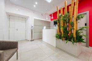 a lobby with a large column with bamboo at Toledo 16 Luxury Suites in Naples