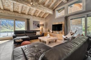 a living room with a couch and a tv at Spacious Apartment in Tignes in Tignes