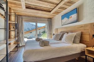 a bedroom with a large bed with a large window at Spacious Apartment in Tignes in Tignes