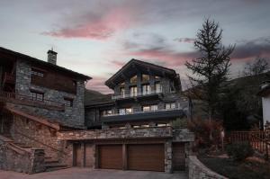 a large stone house with a garage at Spacious Apartment in Tignes in Tignes