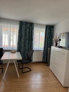 a living room with a table and chairs and windows at Elbstone 2 in Wittenberge