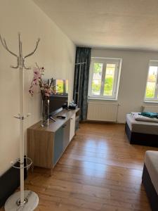 a living room with a room with a bed and a desk at Elbstone 2 in Wittenberge