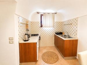 a small kitchen with a sink and a counter at Villa Rosmary in Massa Lubrense +65 photos