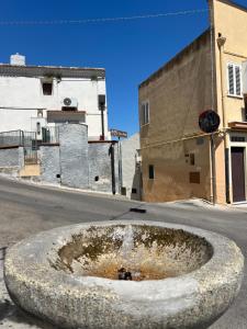 a large stone bowl in the middle of a street at Dimora Lieta in Pisticci