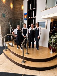 a group of people wearing aprons standing in a room at The Farmers Kitchen Hotel in Wexford