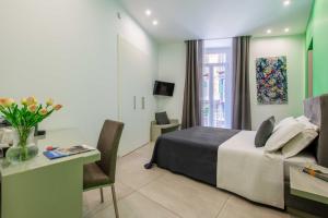 a hotel room with a bed and a table and a desk at Toledo 16 Luxury Suites in Naples