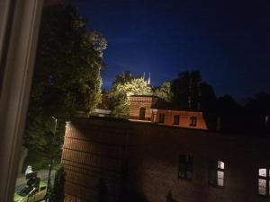 a view of a building at night from a window at PIK-KWATERY in Olsztyn +26 photos