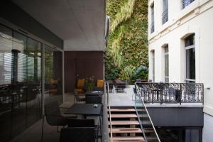 a balcony with tables and chairs on a building at Hôtel C2 in Marseille