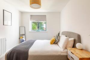 a bedroom with a bed and a window at Fowey Landing in Fowey