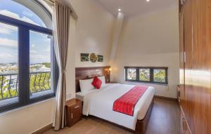 a bedroom with a bed and a large window at Maro Luxury Boutique Villa - hotel in Da Thanh +26 photos