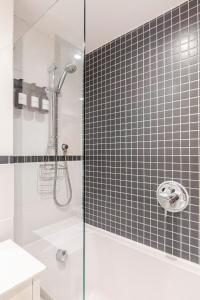 a bathroom with a shower with a glass door at Fowey Landing in Fowey +55 photos