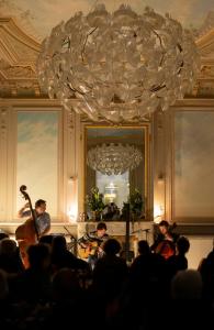 a group of people in a room with a chandelier at Hôtel C2 in Marseille +63 photos