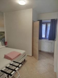 a small bedroom with a bed and a window at Baita Monte Caruso in Filiano