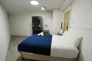 a bedroom with a blue and white bed and a speaker at Hope Harbour Hotel Apartments in Gold Coast +10 photos