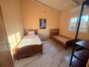 a bedroom with a bed and a bench in it at Casa Verde in Mbocayaty