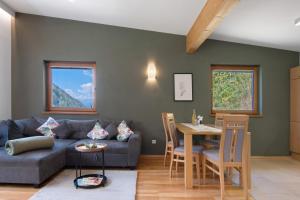 a living room with a couch and a table at Pritscheshof Ferienwohnung Balkon in Malles Venosta