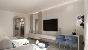 a living room with a television and blue chairs at U North Coast in Sidi Kirayr +15 photos