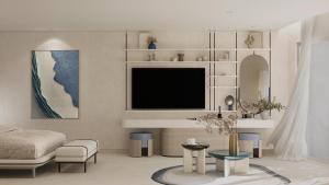 a living room with a bed and a tv at U North Coast in Sidi Kirayr