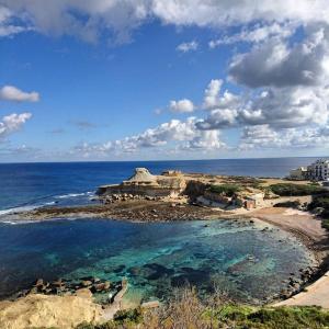 a view of a beach with the ocean at Sunset Seaview Accommodation in Marsalforn