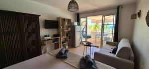 a living room with a couch and a balcony at TI MAD vue mer in Sainte-Anne