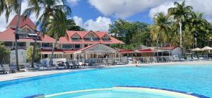 a swimming pool in front of a resort at TI MAD vue mer in Sainte-Anne