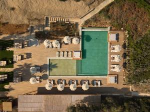 an overhead view of a house with a pool and chairs at Icona's Costa Ragusa Resort - New Opening in Scoglitti