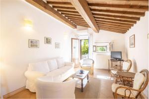 a living room with a white couch and chairs at Casa Bolgheri Castagno in Bolgheri