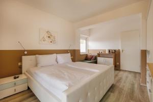 a bedroom with a large white bed in a room at Sun & See in Velden am Wörthersee +68 photos