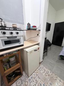 a kitchen with a stove and a small refrigerator at rinconcito en floresta in Buenos Aires