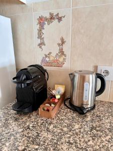a kitchen counter with a coffee maker and a toaster at Villa Gabriela in S'Algar