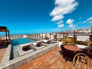 a swimming pool on the roof of a building at LM One Jardim Oceania in João Pessoa