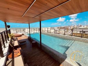 a swimming pool on the roof of a building at LM One Jardim Oceania in João Pessoa