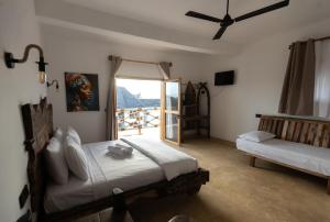 a bedroom with a bed and a sliding glass door at Faro Resort in Nungwi +42 photos