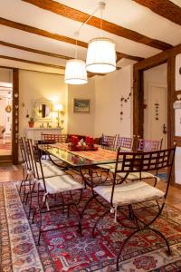 a dining room with a table and chairs at La Maison des Tanneurs in Ribeauvillé