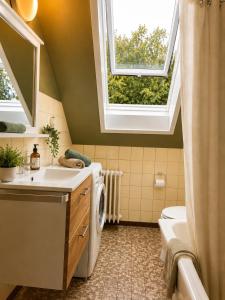 a bathroom with a sink and a washing machine at Odw homes - 3Room Apartment for Workers in Weinheim