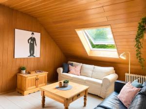 a living room with a couch and a table at Odw homes - 3Room Apartment for Workers in Weinheim +1 photo