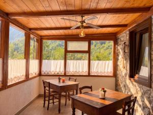 a dining room with two tables and a ceiling fan at Meublé la Ciastella in Vinadio +35 photos