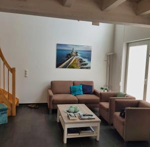 a living room with a couch and a table at Ferienhaus Klabautermann 53 - Nordhorn in Nordhorn