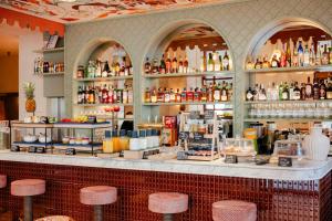 a bar with stools in front of a counter at Posidonia Hôtel in Nice