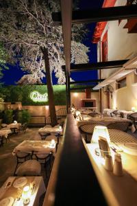a restaurant with tables and chairs at night at imera hotel in Edirne