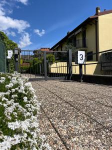 a building with a gate with the number six at OnSuite With Wiew Near COMO in Erba +9 photos