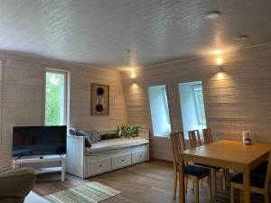 a living room with a couch and a table at Idyllic Charm- with a moat! in Kangasala