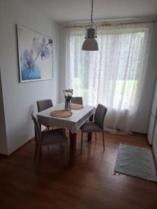 a dining room with a table and chairs and a window at DOMEK na górce u Celiny in Dargobądz +16 photos