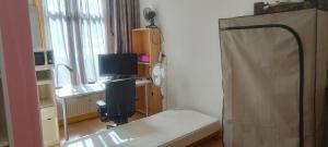 a bedroom with a bed and a desk with a television at Aangenaam & redelijk geprijsd in Amersfoort