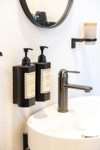 a bathroom with two soap dispensers on a sink at imera hotel in Edirne +81 photos