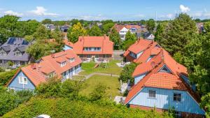 a group of houses with orange roofs on a hill at Heideröschen Park Heideröschen 7a in Zingst